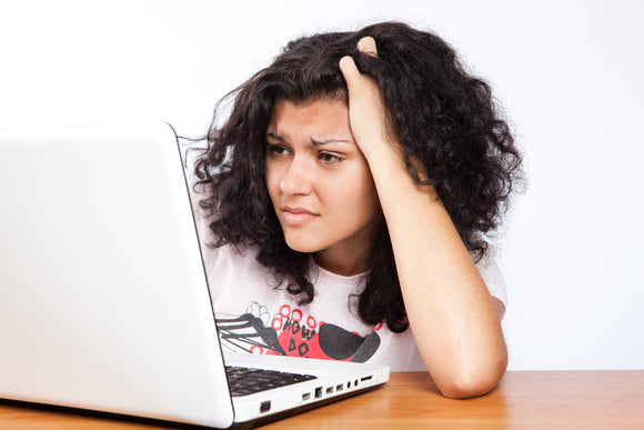 Woman concentrating, while reading on laptop computer https://c2.staticflickr.com/8/7115/7658225516_00cf277f83_b.jpg